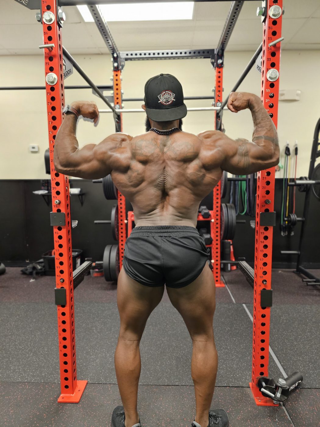 Darian Bailey hitting a back double biceps pose during posing practice