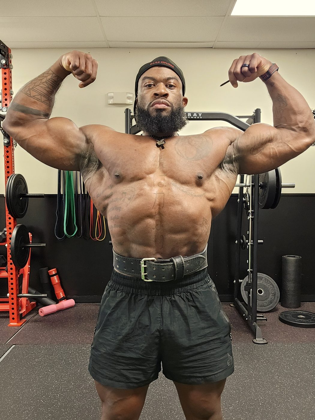 Darian Bailey hitting a front double biceps pose in the gym